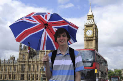 Big Ben and a tourist with British flag umbrella